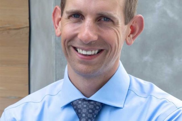 profile photo of cooper lord smiling wearing blue dress shirt and tie