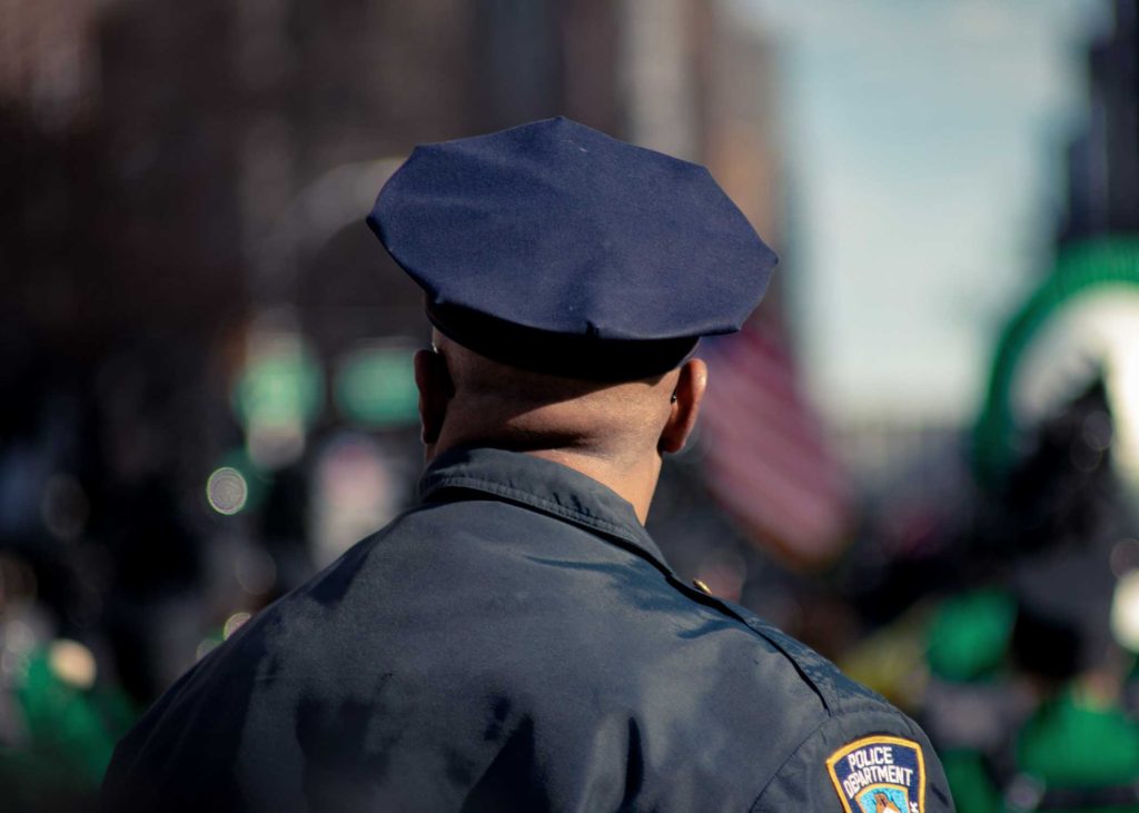 back of police man's head and shoulders in uniform