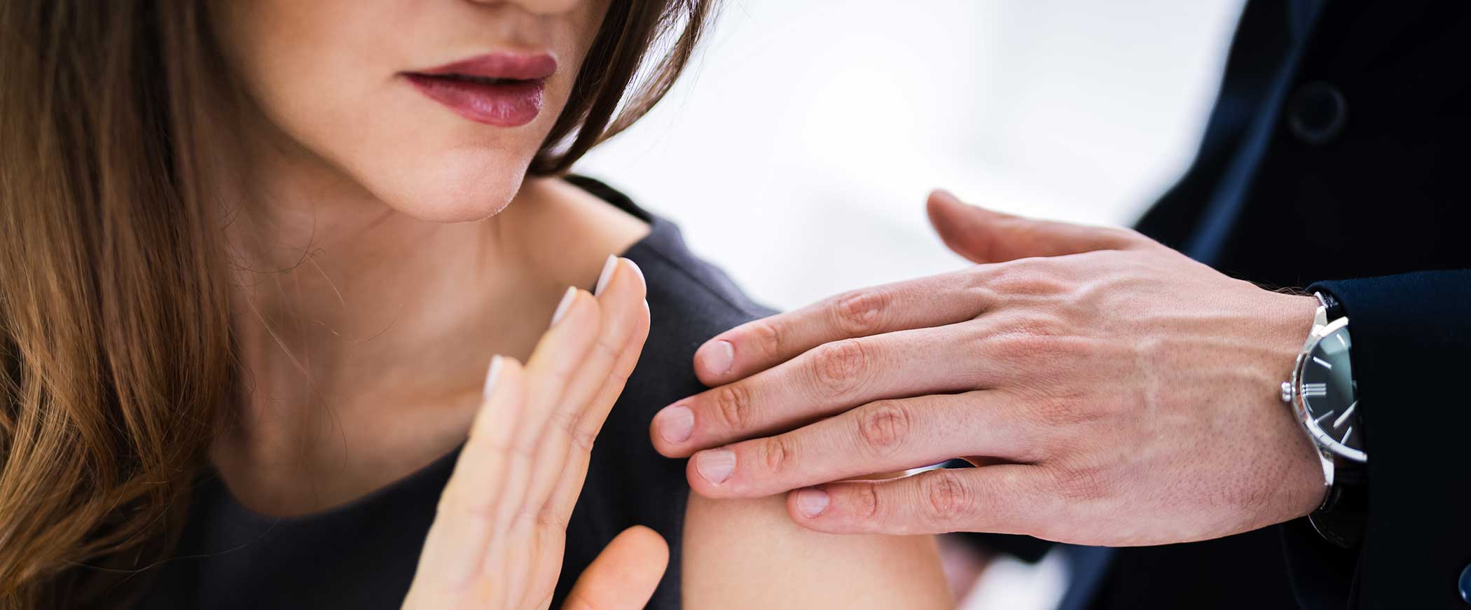 hand placed on woman's shoulder